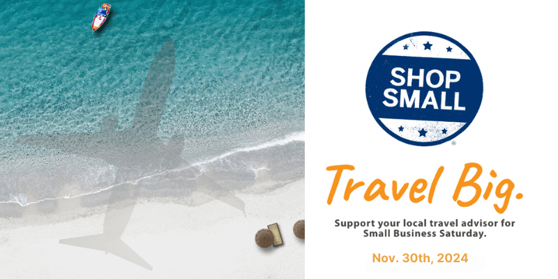 An aerial beach view showing turquoise waters, white sand, and a small boat. On the right, text reads "Travel Big" with the "SHOP SMALL" logo and messaging about supporting local travel advisors for Small Business Saturday on Nov. 30th, 2024.